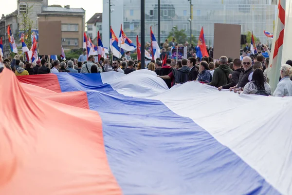 stock image Political rally of people waves big serbian flag. Protest in front of building.