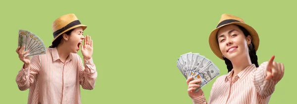Web banner of advertising. Two young Caucasian women in a straw hat screaming, point with finger and shows a fan of dollar bills. Concept of banking, feedback and shopping.