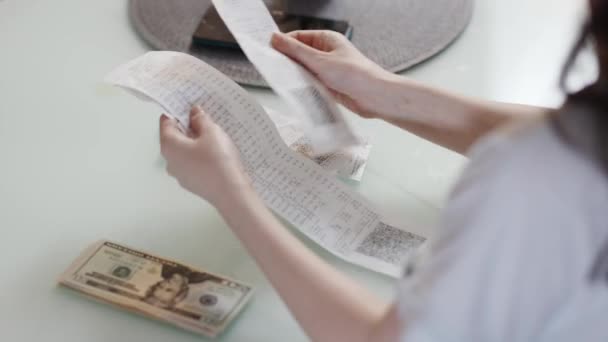 Planning Expenses Woman Lays Out Dollars Store Paper Receipts Home — Stock Video