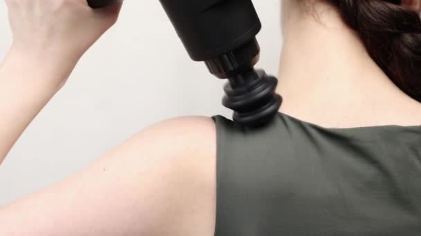 Close View Woman Gives Herself Massage Upper Arm Percussion Massager — Stock Video