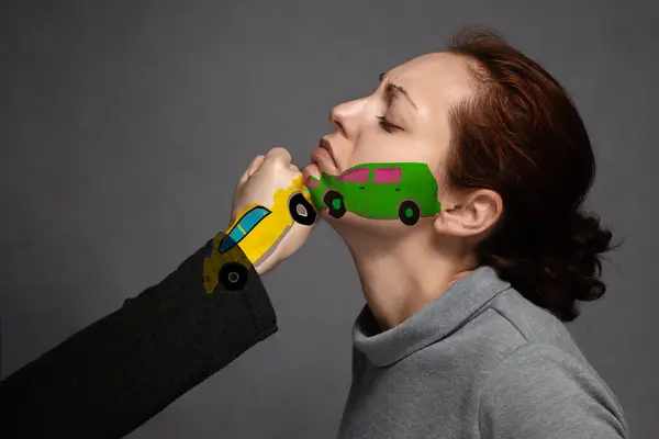 stock image The concept of a car accident, insurance.Sudden collision of cars . the woman's face and on the fist, painted cars in a collision.