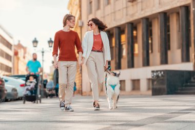 Genç, beyaz, evli bir çift, şehirde safkan bir köpekle dolaşıyor. Hayvan eğitimi..