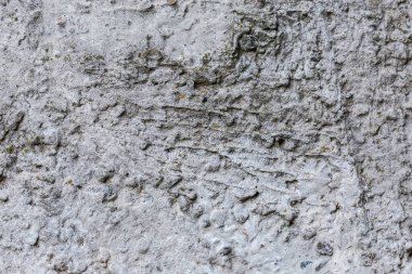 Sert bir yüzeyi olan eski beton duvarın parçası, açık havada, bulutlu havada, arka planda, yapıda.