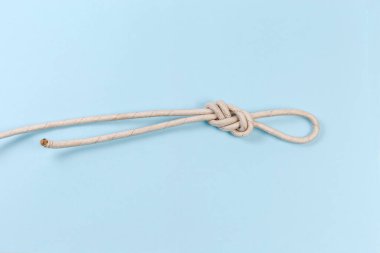 Rope knot as igure-eight loop, also known as Flemish loop on a blue background