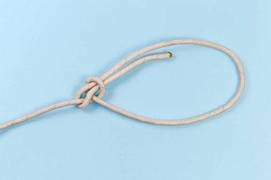 Rope knot bowline, or boling knot on a blue background