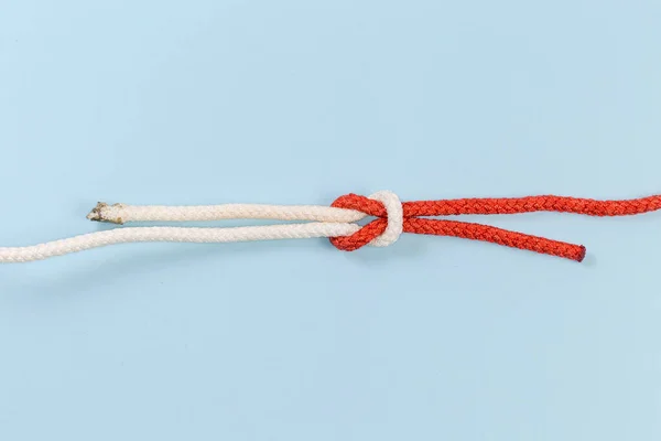 Rope thief knot, also known as bag knot on a blue background