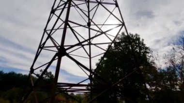 Lattice steel transmission tower of overhead power line against sky