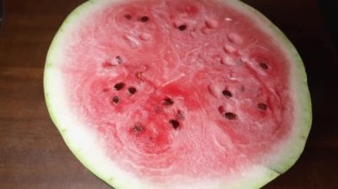 Half of watermelon on the table, top view while panning