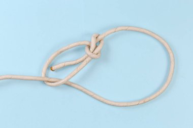 Rope knot Running bowline used in maritime, view on a blue background