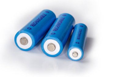 Blue rechargeable nickel metal hydride batteries AA and AAA sizes on a white surface, close-up in selective focus