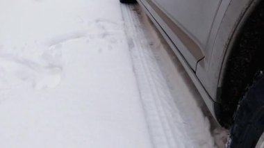 Part of car wheels and tire tracks on a snow