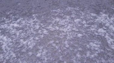 Surface of hood and windshield of car during strong snowfall