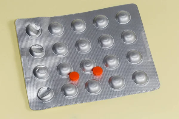 Dos Píldoras Rojas Medicación Encuentran Blister Aluminio Sobre Una Superficie —  Fotos de Stock