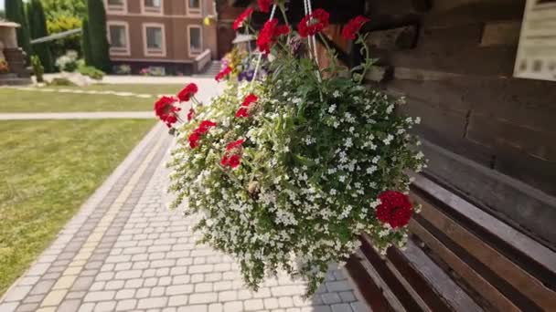 Květináč Různými Květinami Zavěšený Pod Střechou Dřevěného Kostela — Stock video