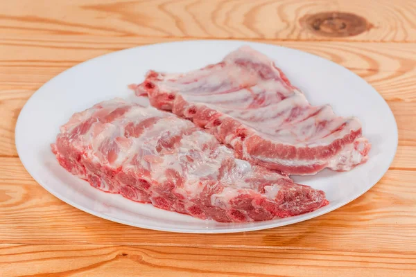 Two Pieces Raw Pork Ribs White Dish Rustic Table Side — Stock Photo, Image