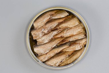 Açık teneke kutuda tütsülenmiş lahanalar, gri arka planda yakın plan görüntüler.