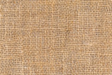 Doğal boyanmamış, farklı kalınlıkta, düz dokuma, arkaplan, doku ve dokuma ile örülmemiş kenevir ipliğinden örülmüş çok kaba çuval bezi parçasının üst görünümü