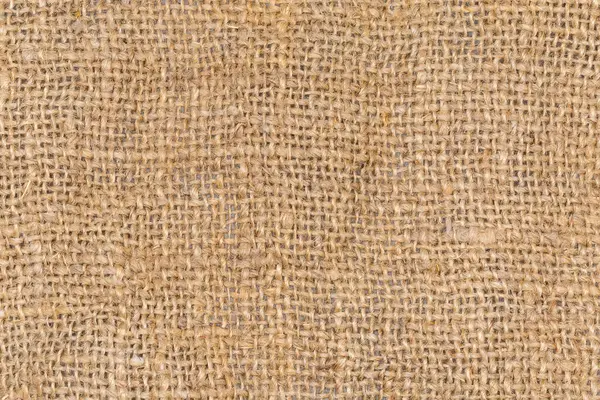 Doğal boyanmamış, farklı kalınlıkta, düz dokuma, arkaplan, doku ve dokuma ile örülmemiş kenevir ipliğinden örülmüş çok kaba çuval bezi parçasının üst görünümü