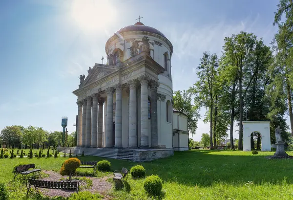 Baroque Roman Catholic church of St. Joseph built in the 18th with inscription on main facade translated from Latin - TO THE GLORY OF OUR LORD GOD, Pidhirtsi village, Ukraine, view backlit