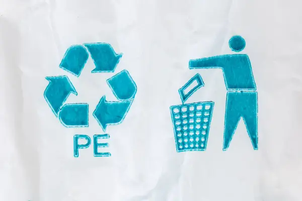 Blue universal recycling symbol with recycling code and tidy man symbol called to dispose encourage of packaging in the waste bin pictured on white polyethylene bag