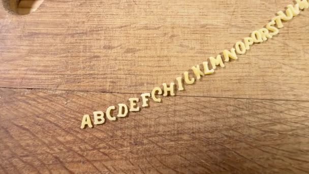 Raw Alphabet Pasta Cutting Board Lined Heap — Stock Video