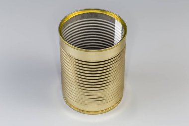 Open empty tin can from under a canned food, with yellow covering outside on a gray background clipart
