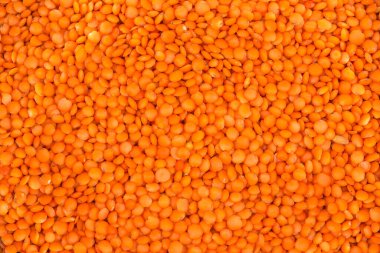 Ham kırmızı mercimek yığını yüzeyi, üst görünüm yakın plan, arka plan