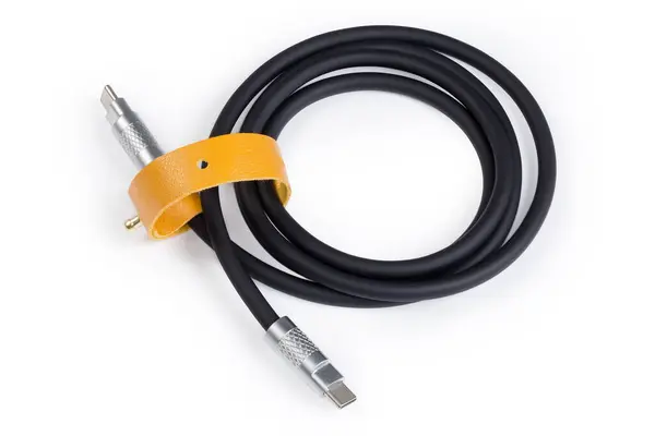 stock image Coiled black thick cable USB with plugs USB Type-C at the both edges on a white background