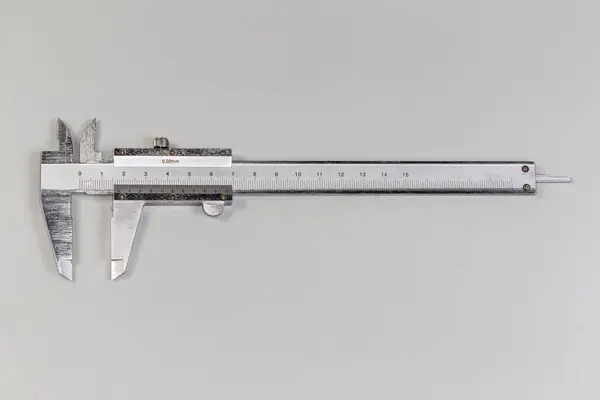 stock image Vernier caliper with metric main and secondary scales used to accurate measure linear dimensions, top view on a gray surface