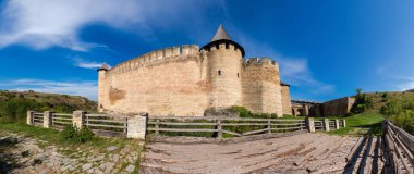 Khotyn fortress of the 14th century at autumn sunny day, Ukraine. Panoramic view from the west of the defensive walls and towers with old bridge on a foreground clipart