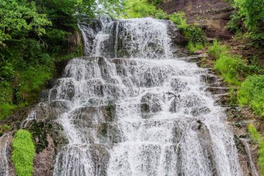 Dzhurynskyi ya da Chervonohorodskyi şelalesinin üst çağlayanı bahar bulutlu gününde Dzhuryn nehrinde, Ukrayna 'da.
