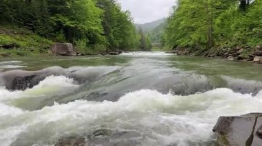 Probiy waterfall on Prut River in Carpathians in overcast day
