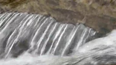Rushing water stream in cascade waterfall on mountain river