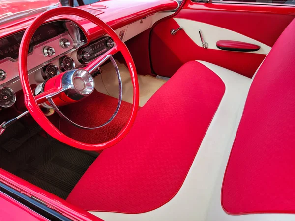 带有长椅和方向盘的亮红色和白色老式轿车内部 — 图库照片