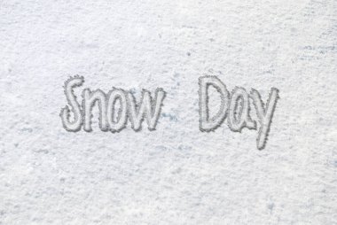 Snow day text in white snow on the ground 