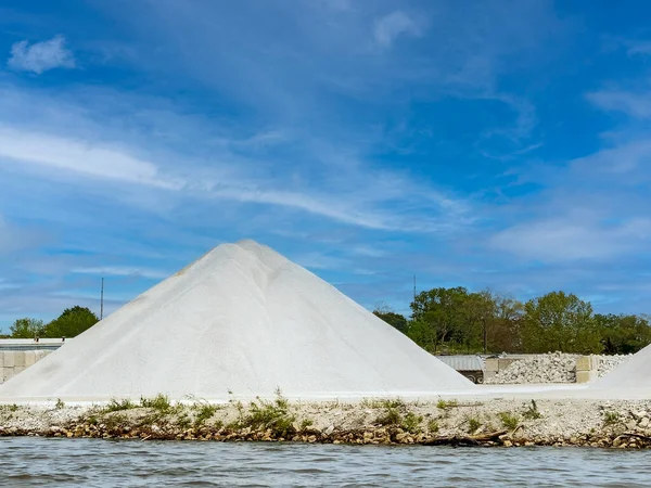 stock image A pile of white stone at the water edge