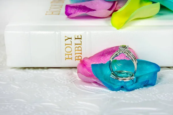 Обручальные Кольца Красочных Лепестках Роз Белой Библией — стоковое фото