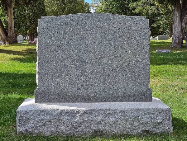 stock image Blank gray granite tombstone in a cemetery 