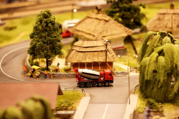 A car carrying concrete at an intersection. Landscape layout with railroad, cars, residential and industrial buildings. Monuments of architecture and sights. Hobbies of building miniatures