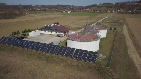 Flying over a sewage treatment plant from a bird\'s eye view. The sewage treatment plant is equipped with solar panels to obtain ecological energy for the operation of the filters.