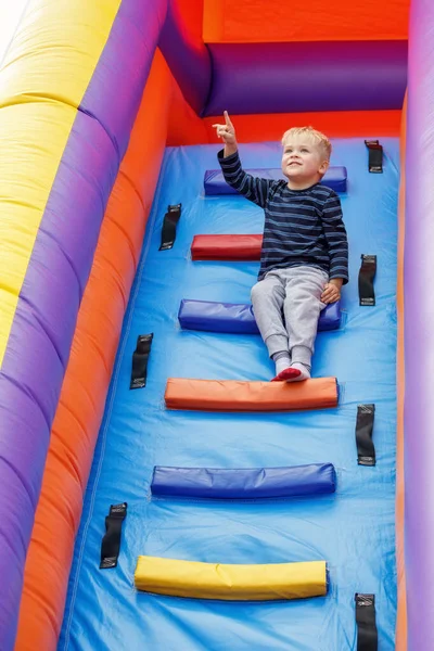 Brave Clever Little Sympathetic Boy Sits Ladder Large Inflatable Trampoline — Stock Photo, Image