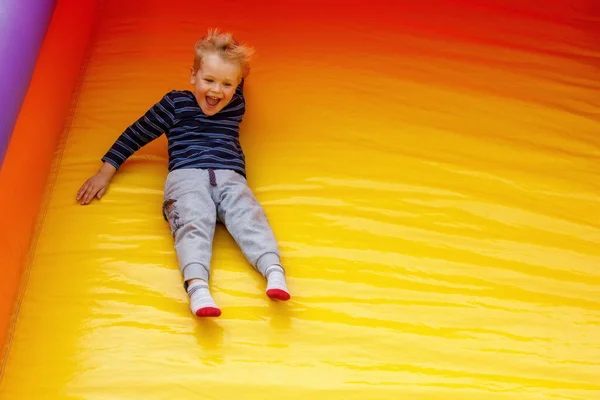 Hilarious Little Boy Slides High Speed Large Bright Yellow Trampoline Imagen De Stock