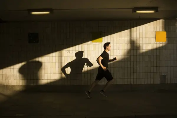 Young Man Jogging Tiled Wall — Stock Photo, Image