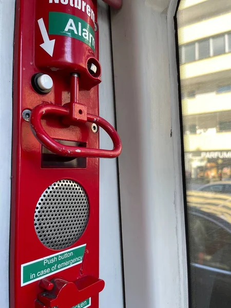 Cropped close up of red emergency alarm breaks in modern public transport