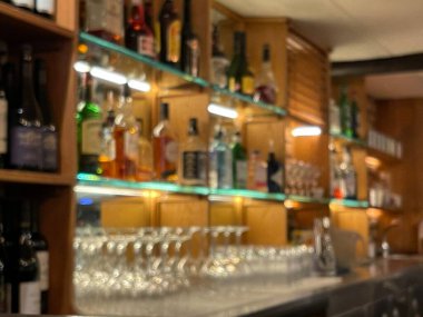 Blurred background shot of many liquor bottles at the bar