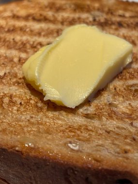 Close up of butter on freshly toasted bread
