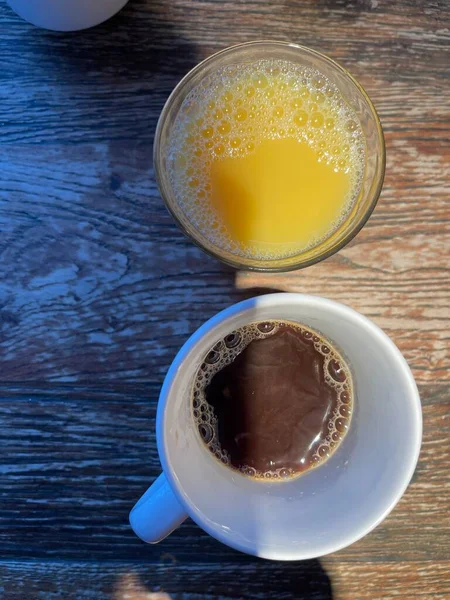Top View Shot Orange Juice Glass Cup Black Coffee Wooden — Stockfoto