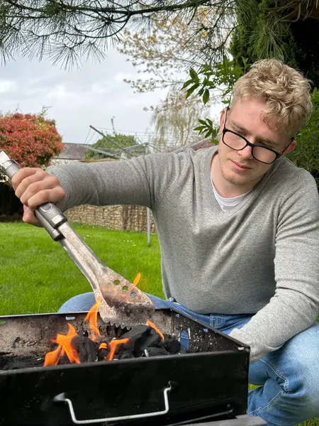 Vertical Shot Handsome Man Starting Barbecue Fire Grill Pit Using — Stock Photo, Image