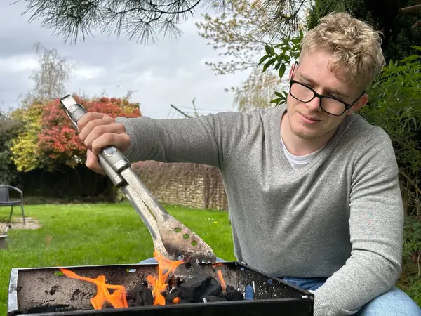 Young Man Starting Barbecue Grill Flame Having Bbq Party His Royalty Free Stock Photos