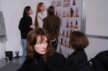 Kyiv, Ukrayna - 14 Şubat 2025: Ukrayna Moda Haftası 'nda, modeller ve tasarımcılar son düzenlemeleri yapar, kıyafetleri gözden geçirir ve defilede tasarımcılığı tartışırlar..